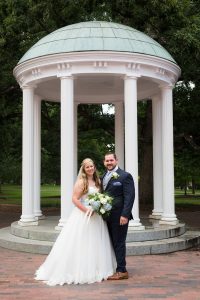 Laura Caroline Spell and husband Ross Rick at the Old Well in Chapel Hill, NC